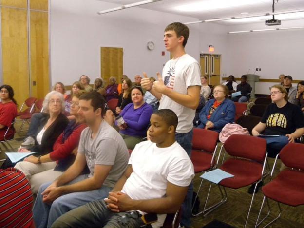 Young man speaking at the auditorium of the Champaign Public Library