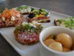 A table displaying several types of open faced sandwiches.