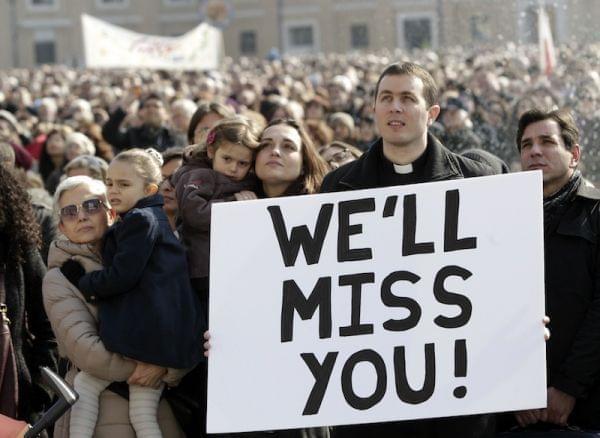 A priest displays a placard in St. Peter's Square at the Vatican