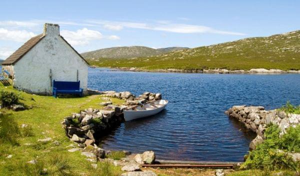 Lake with tied rowboat in Connemara, Ireland