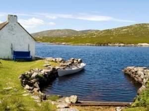 Lake with tied rowboat in Connemara, Ireland