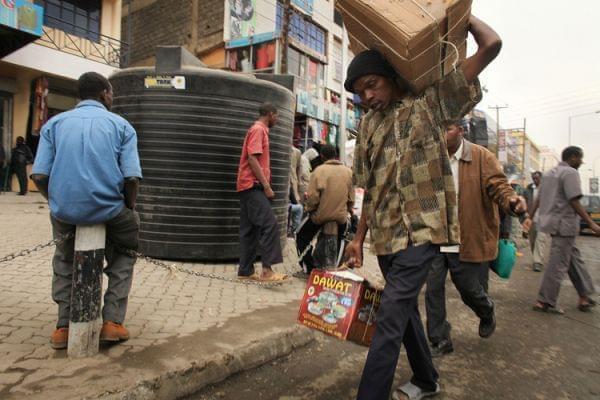 People walk down a market street in Eastleigh