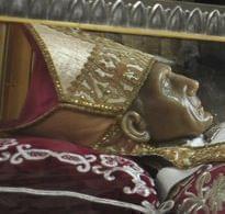 Pope Benedict XVI stands by remains of Pope Celestine V.