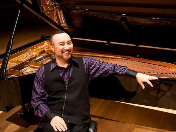 Joh Kimura Parker posing on piano bench