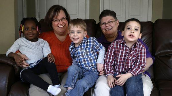 April DeBoer (second from left) sits with her adopted daughter Ryanne, 3, and Jayne Rowse and her adopted sons Jacob, 3, and Nolan, 4, at their home in Hazel Park, Mich., on Tuesday.