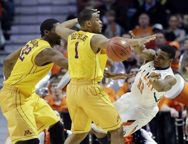 Illinois' Tracy Abrams passes around Minnesota's Andre Hollins (1) and Trevor Mbakwe (32) during the second half of an NCAA college basketball game at the Big Ten tournament Thursday, March 14, 2013, in Chicago.