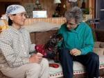 Frances Herbert, right, and her wife, Takako Ueda, pose for photos with their dog, Little Bear, at their home in Dummerston, Vt., Wednesday, Dec. 21, 2011.