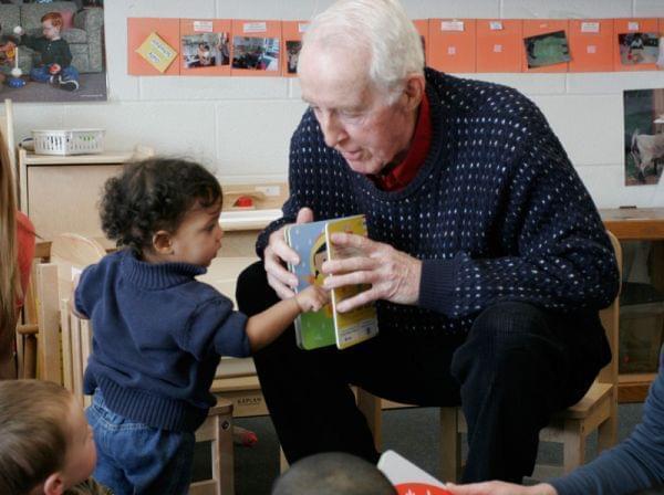 George Willhite reading to toddlers