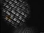 This image shows a nanoparticle with atomic resolution. It is a projection image of the nanoparticle where darker atomic columns represent Se columns while the brighter columns are Cd (atomic structure has been partially overlayed to highlight the at