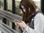 Ruobing Ma, a senior at the University of Illinois at Urbana-Champaign, looks at her cell phone.