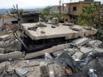 In this photo released by the Syrian official news agency SANA, damaged buildings wrecked by an Israeli airstrike are seen in Damascus, Syria, Sunday, May 5, 2013.