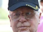 Close up of the face of a world war two veteran. He has a retrospective look, and is wear a world war two hat.