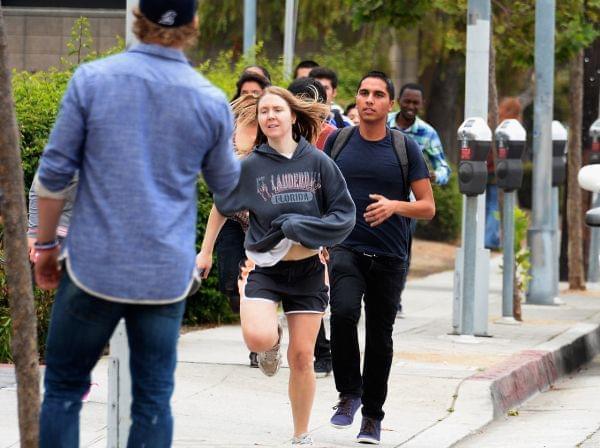 Students rush to safety after shots were fired near the Santa Monica College Friday.