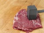 Meat tenderized the old-fashioned way. The industrial method is a mechanized process involving needles.