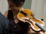 Violinist Amandine Beyer holds Mozart's own violin backstage at Boston's Jordan Hall on Monday.