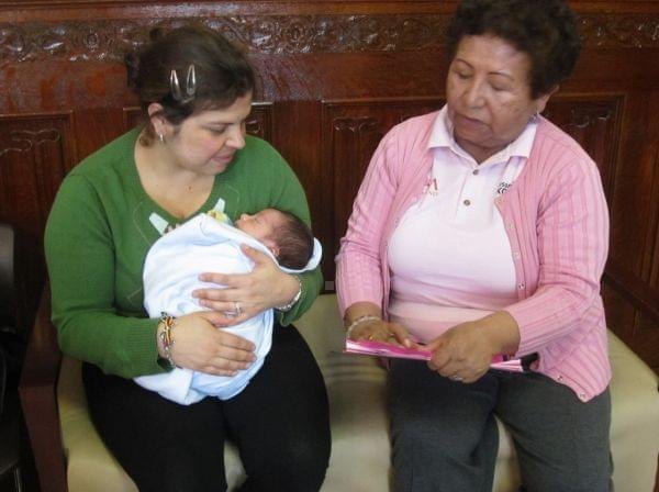 Elva Jaldin, a promotora, talks with Andrea Velandia about health. Soon Jaldin will help women like Velandia sign up for health insurance under the Affordable Care Act.
