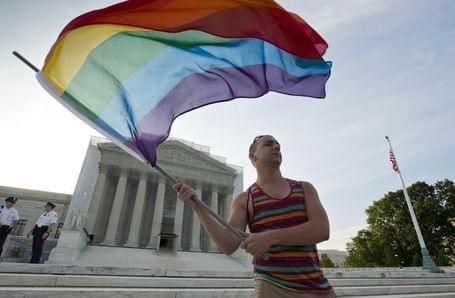 Gay rights advocate Vin Testa waving a rainbow flag in front of the U.S. Supreme Court building