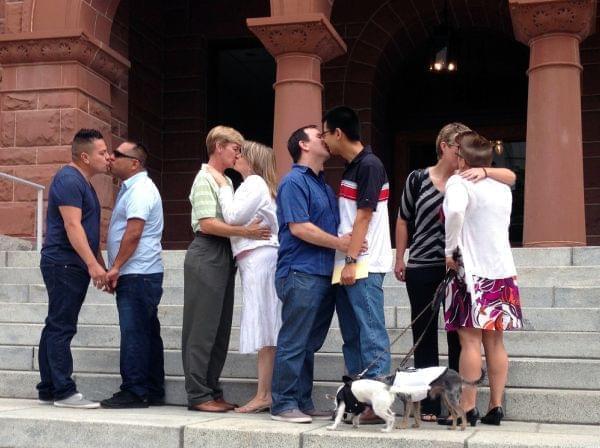 Couples kiss at the Old Orange County Courthouse in Santa Ana, California