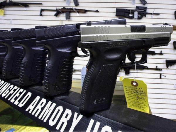 In this Wednesday, Jan. 16, 2013 photo, semi-automatic handguns are seen on display at Capitol City Arms Supply in Springfield, Ill.
