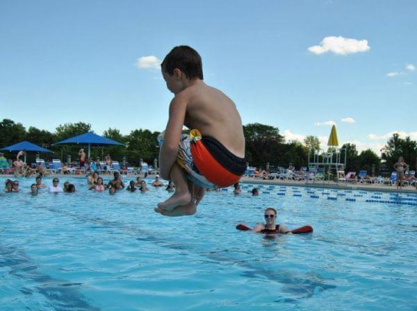 a child doing a cannonball at Sholem Aquatic Center