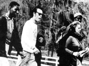 Viola Liuzzo carries her shoes while walking with other civil rights activist
