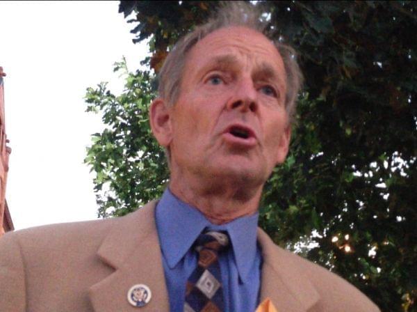 Former U.S. Rep. Tim Johnson (R-Urbana) speaks during a candle light vigil in opposition to a possible military strike in Syria.