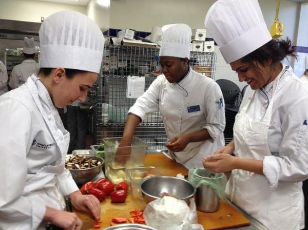 Fourth year Tulane medical school student Neha Solanki (far right) preps a Greek frittata during a class at Johnson & Wales.
