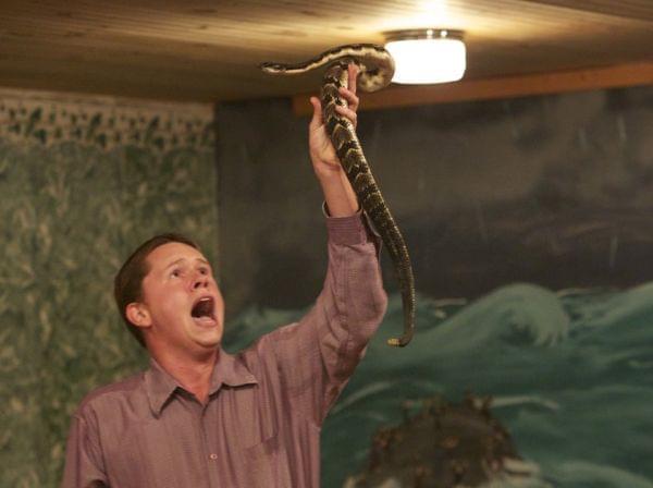 Andrew Hamblin preaches while holding a snake above his head, LaFollette, Tenn.