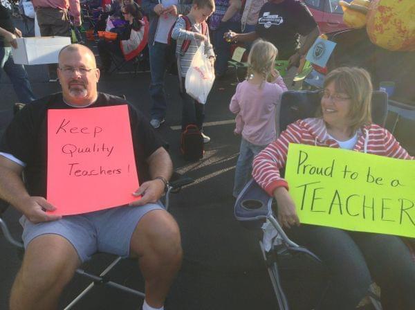 Champaign Unit 4 teachers Jim McCune and Karen Ranney show their support on Monday, Oct. 7, 2013 outsidethe Mellon Administrative Building in Champaign as contract talks continue.