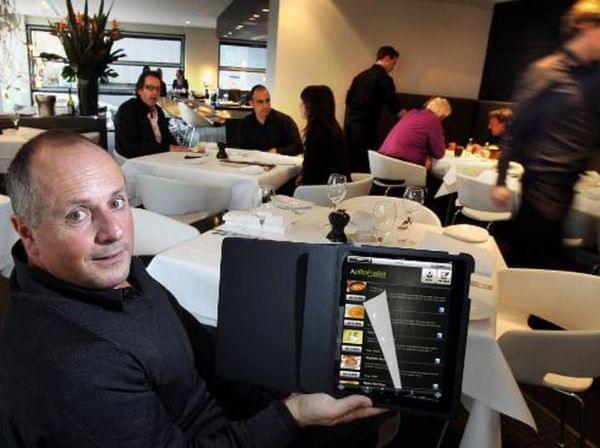 A restaurant customer tries out the Aptito app on a digital menu.