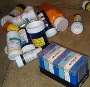 a pile of medicine bottles on a table