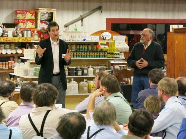 Michael Doherty with the Illinois Farm Bureau, left, speaks with a group of Amish farmers at a recent food hub education meeting. Standing next to him is organizer Dave Bishop.