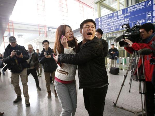 Woman believed to be relative of passenger of Malaysia Airlines flight cries