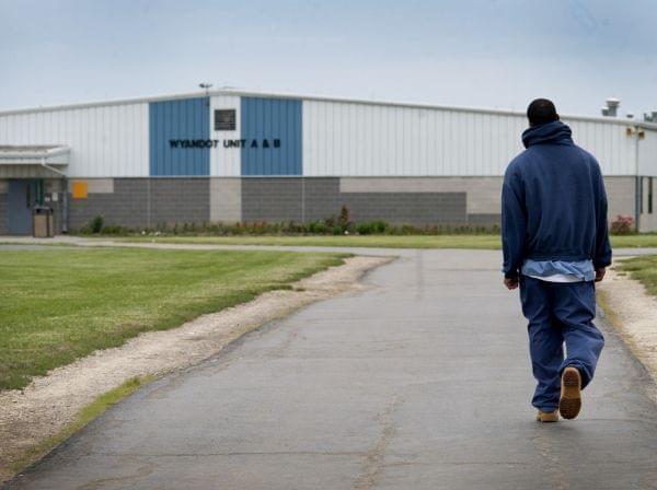 An inmate walks through the yard at the North Central Correctional Institution in Marion, Ohio, which recently switched to private management.
