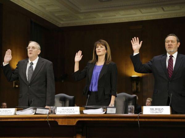 Caterpillar Inc Vice President for Finance Services Julie Lagacy is flanked by former Senior International Tax Manager Rodney Perkins (left) and Chief Tax Officer Robin Beran (right) as they are sworn in to testify on Tuesday.