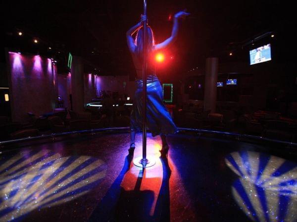 In this Feb. 23, 2009 file photo, Rebecca Brown begins her first three-song set of the evening at the Pink Monkey gentlemen's club in Chicago.