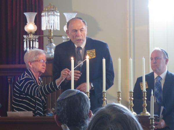 Doris Fogel, left, lit one of six candles at the Holocaust Memorial Ceremony in Springfield. Each candle represents one million Jews killed by the Nazis.