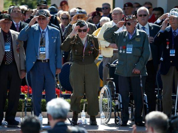 World War II veterans salute as taps is played at a ceremony at the Normandy American Cemetery at Colleville-sur-Mer on Friday, marking the 70th anniversary of D-Day.