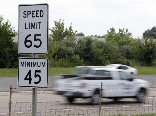 In this Aug. 16, 2013 file photo, vehicles pass a 65 mph speed limit sign along Interstate 64 in O'Fallon, Ill. Illinois Gov. Pat Quinn signed into a law a bill allowing motorists to drive 70 mph on rural interstates.
