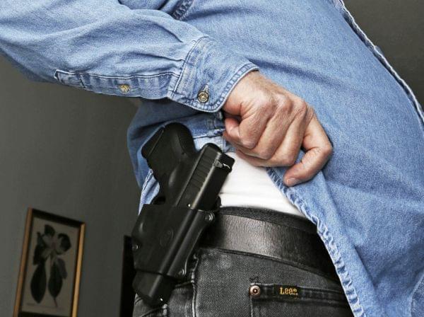 Hank Johnson displays his Glock handgun, inside his home in Springboro, Ohio. D.C. lawmakers had hoped to maintain a ban on carrying handguns in public, but a district court last week overturned it.