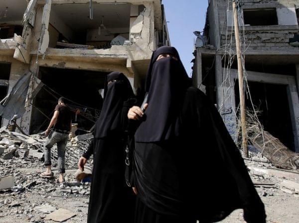 Palestinian women walk in Gaza City's Shijaiyah neighborhood