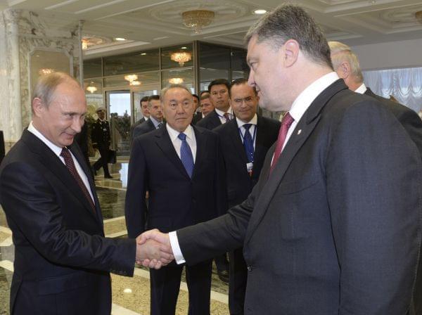 Vladimir Putinshakes hands with Ukrainian President Petro Poroshenko,after posing for a photo in Minsk, Belarus, August 26.