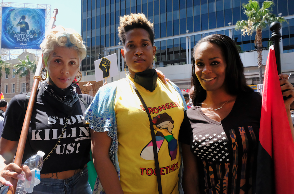 Trans women Carlisha Brown, from left, Nina Barkers, and Vanessa Warri, of Los Angeles at an All Black Lives Matter march