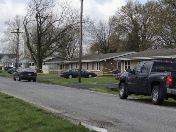 Police tape is seen around a house in Manchester, Ill., Wednesday, April 24, 2013, where the bodies of five people were found slain early Wednesday in the tiny southwestern Illinois town. Authorities said a suspect was injured and taken into custody. 