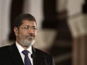 In this Friday, July 13, 2012 file photo, Egyptian President Mohammed Morsi holds a joint news conference with Tunisian President Moncef Marzouki, unseen, at the Presidential palace in Cairo, Egypt. The armed forces ousted Egypt's first democratically elected president Wednesday after just a year in power, installing a temporary civilian government, suspending the constitution and calling for new elections.