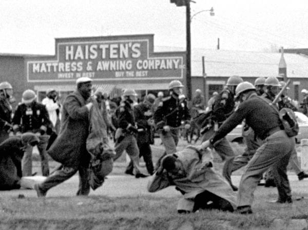 State troopers swing billy clubs to break up a civil rights voting march in Selma, Ala., on March 7, 1965. John Lewis, then-chairman of the Student Nonviolent Coordinating Committee (in the foreground) is being beaten by state troopers.