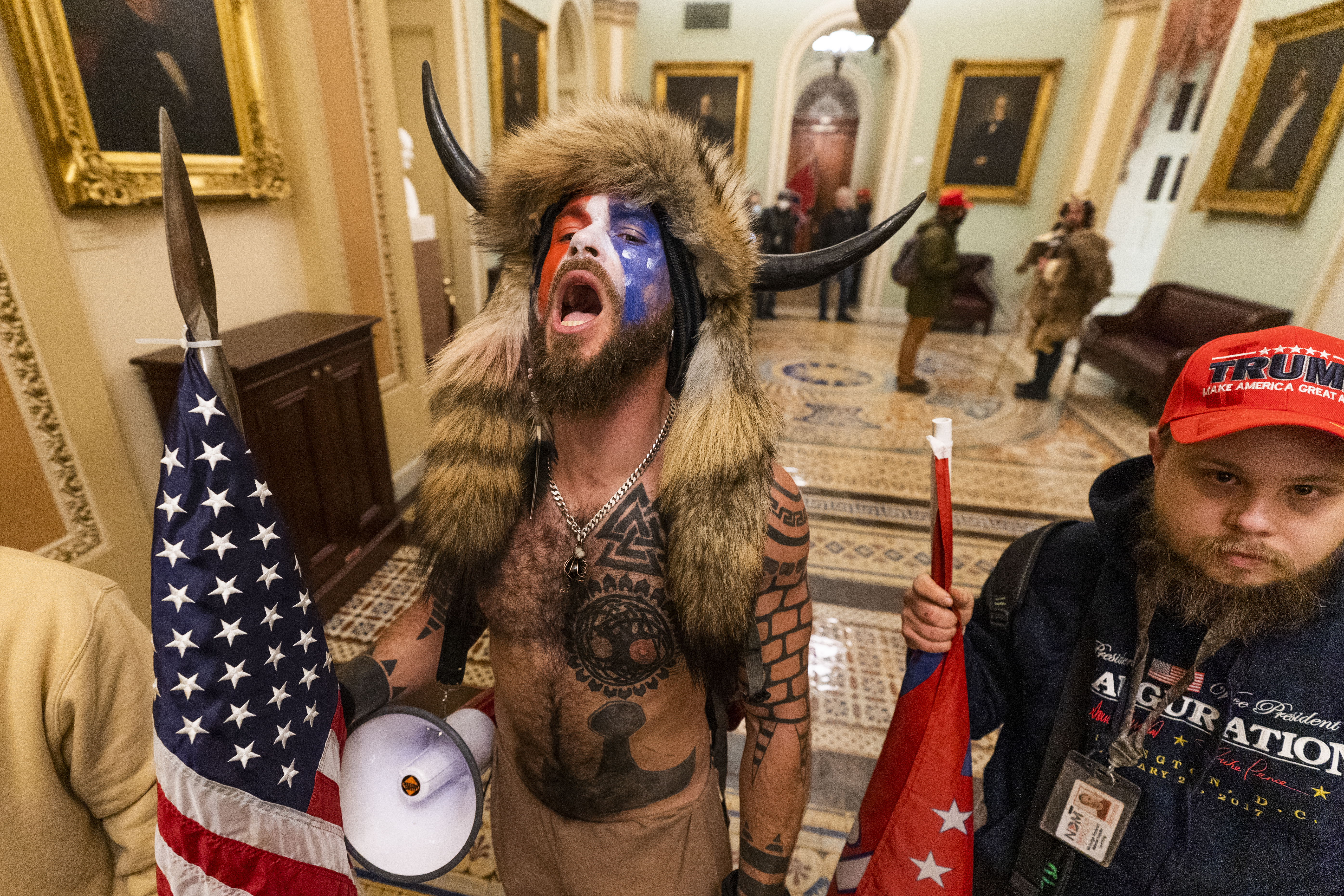 A supporter of President Donald Trump chants outside the Senate Chamber inside the Capitol, Wednesday, Jan. 6, 2021 in Washington.