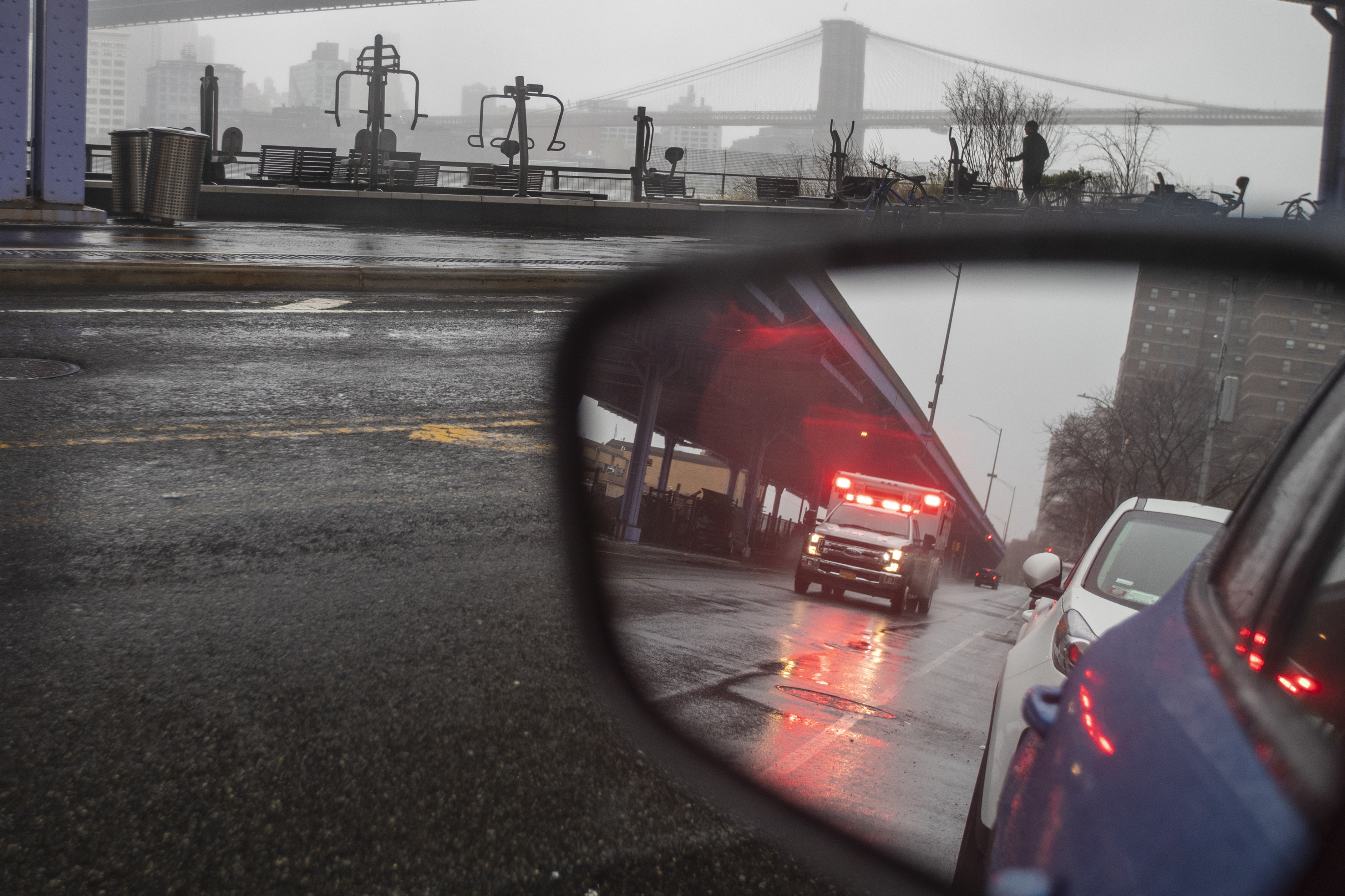 An ambulance is seen with it's emergency lights on in lower Manhattan, Sunday, March 29, 2020. The new coronavirus causes mild or moderate symptoms for most people, but for some, especially older adults and people with existing health problems, it can cause more severe illness or death.