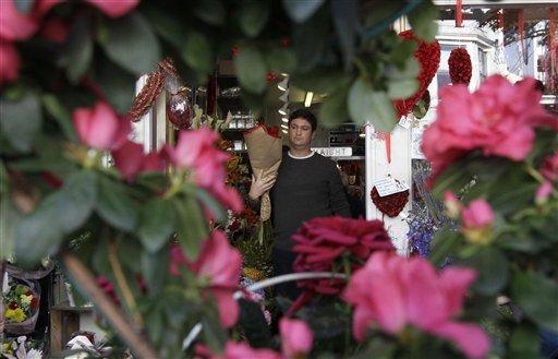 Mark Dorshkind carries roses he bought for Valentine's Day at Flowers of the Valley in San Francisco, Tuesday, Feb. 14, 2012.