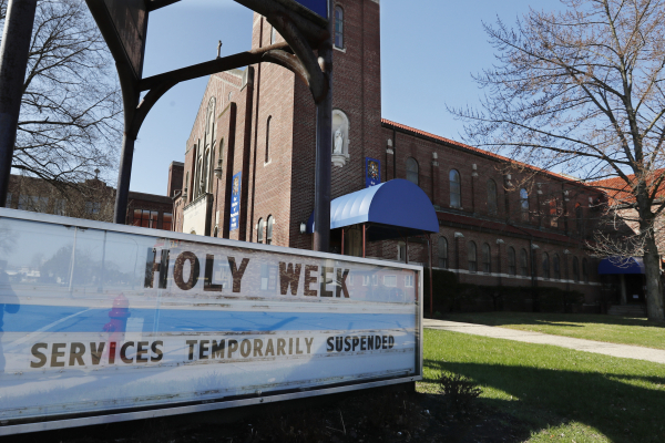 A sign highlighting Holy Week activities is displayed outside the Our Mother of Perpetual Help- St. James Parish, Wednesday, April 8, 2020, in Ferndale, Mich. Church activities during Holy Week are being suspended across the state and the world as the coronavirus pandemic continues spreading.